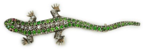 An Edwardian yellow metal, diamond and green garnet set lizard brooch, with red cabochon eyes, 50mm,