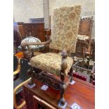 A reproduction Jacobean style mahogany upholstered elbow chair, width 64cm, depth 51cm, height
