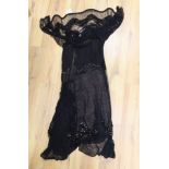 An early 20th century ladies black silk net and chiffon, beaded and sequin evening dress