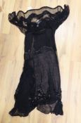An early 20th century ladies black silk net and chiffon, beaded and sequin evening dress