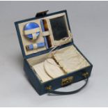 A lady's 1920's small leather vanity case, containing an enamelled comb, pill box and lipstick