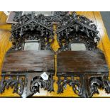 A pair of Black Forest carved folding mirrored wall brackets width 37cm height 81cm.