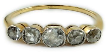 A yellow metal and graduated collet set five stone diamond half hoop ring, size V, gross weight 2.