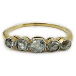 A yellow metal and graduated collet set five stone diamond half hoop ring, size V, gross weight 2.