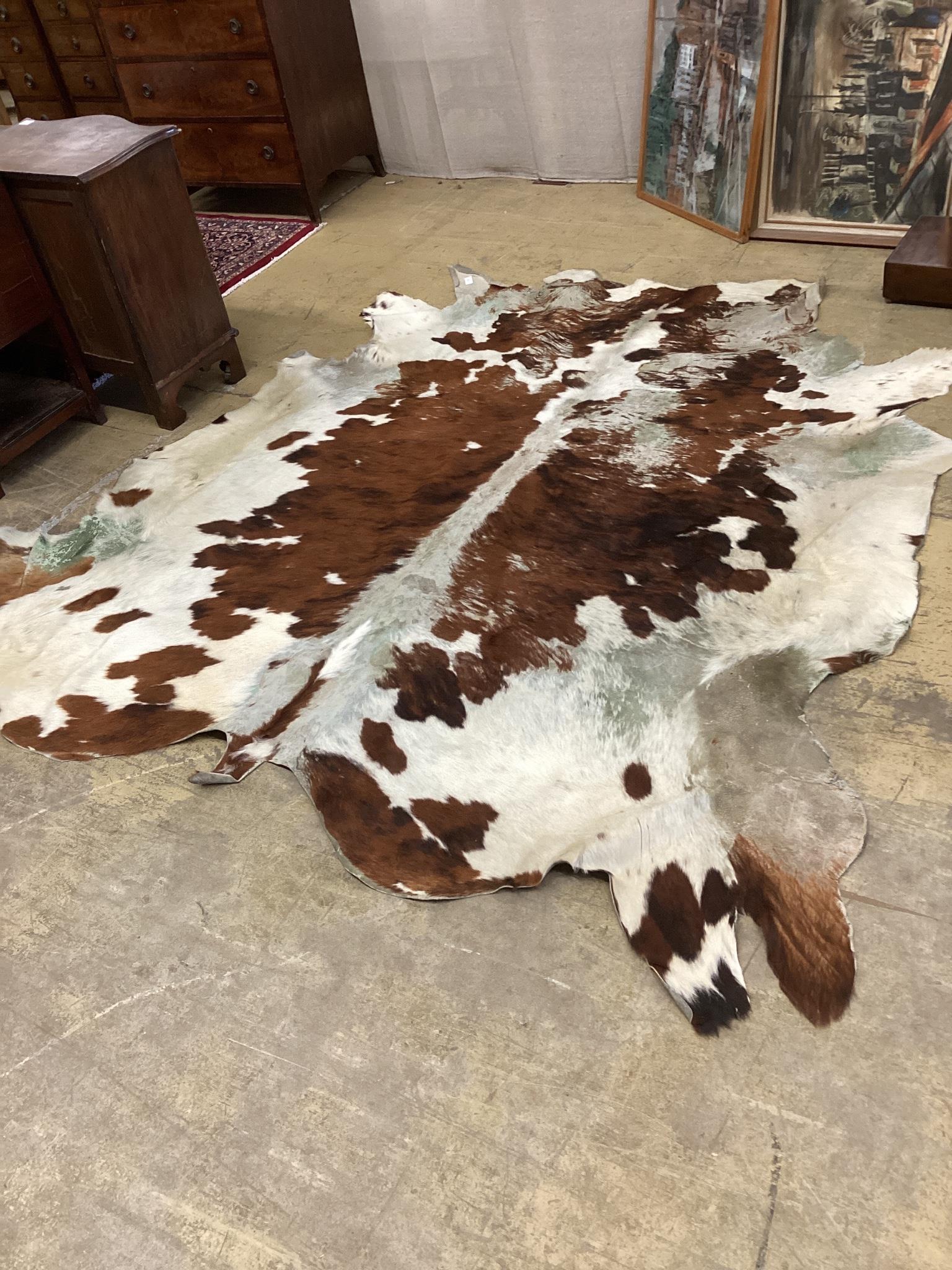 A cow hide rug, width 205cm