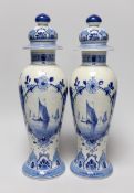 A pair of blue and white Delft vases and covers, 28cm