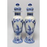 A pair of blue and white Delft vases and covers, 28cm