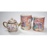 Two Chinese export 'mandarin' mugs and a similar teapot, Qianlong period, tallest mug 14cms high