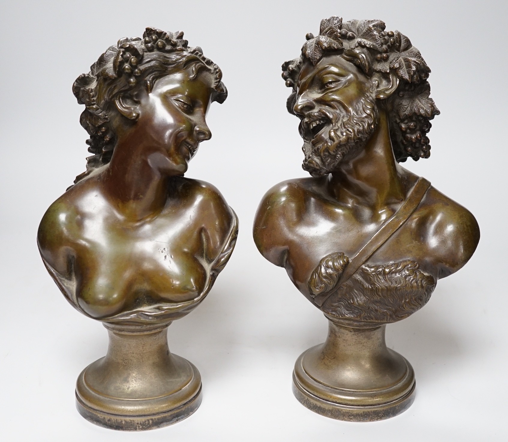 A pair of late 19th century French bronze Bacchic busts, on plated socles, 28cm
