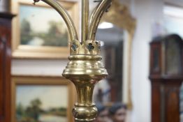 A pair of Victorian Gothic brass ecclesiastical three branch floor lamps, converted to