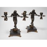 Eugene Cartier (1861-1943). A pair of bronze ‘acrobat’ candelabra, 24cm