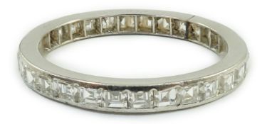 A white metal and square cut diamond set full eternity ring, size M/N, gross weight 2.3 grams.