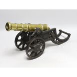 A cast iron and brass model cannon, 47cm long