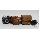 Three cameras, two cased plus a flash and light meter