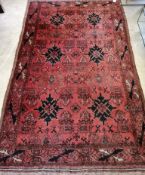 A Belouch geometric red ground rug, 190 x 117cm