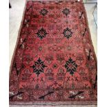 A Belouch geometric red ground rug, 190 x 117cm