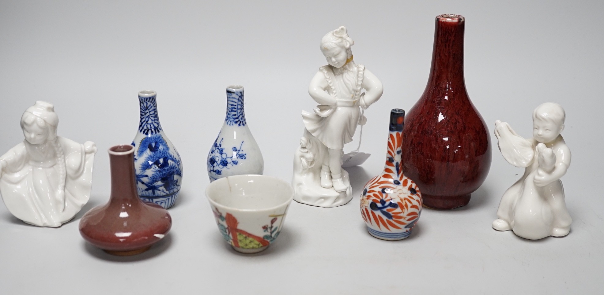 A Chinese sang de boeuf bottle neck vase, together with four Chinese miniature vases, three