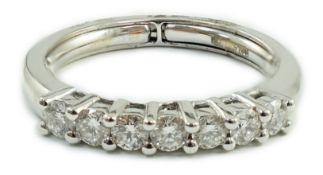 A modern Italian 18ct white gold and seven stone diamond set half hoop ring, size N, gross weight