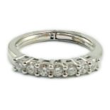 A modern Italian 18ct white gold and seven stone diamond set half hoop ring, size N, gross weight