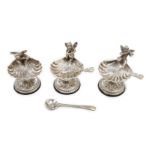 A set of three 20th century Spanish white metal shell pedestal salts with cherub handles and three