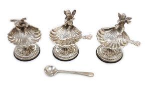 A set of three 20th century Spanish white metal shell pedestal salts with cherub handles and three
