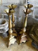 A set of four large brass candlesticks, height 74cm