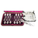 A cased set of twelve Victorian silver teaspoons, with pierced terminals by William Comyns, London