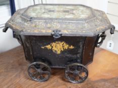 A Victorian gilt lacquer coal scuttle on wheels with glass inset top, 63cm long