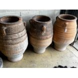 Three Greek terracotta oil jars, largest height 91cm