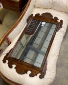 A reproduction 18th century style walnut fret-cut wall mirror, width 48cm, height 91cm