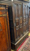 An 18th century style oak linenfold moulded wardrobe, width 123cm, depth 53cm, height 185cm