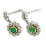 A modern pair of 18ct white gold, emerald and diamond cluster set drop earrings, 16mm, gross