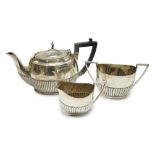 A matched early 20th century silver bachelor's three piece tea set, tea pot, James Dixon & Sons,