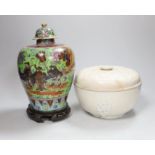 A Chinese clobbered vase and cover, and a blanc de chine bowl and cover, tallest 30cms high (2)