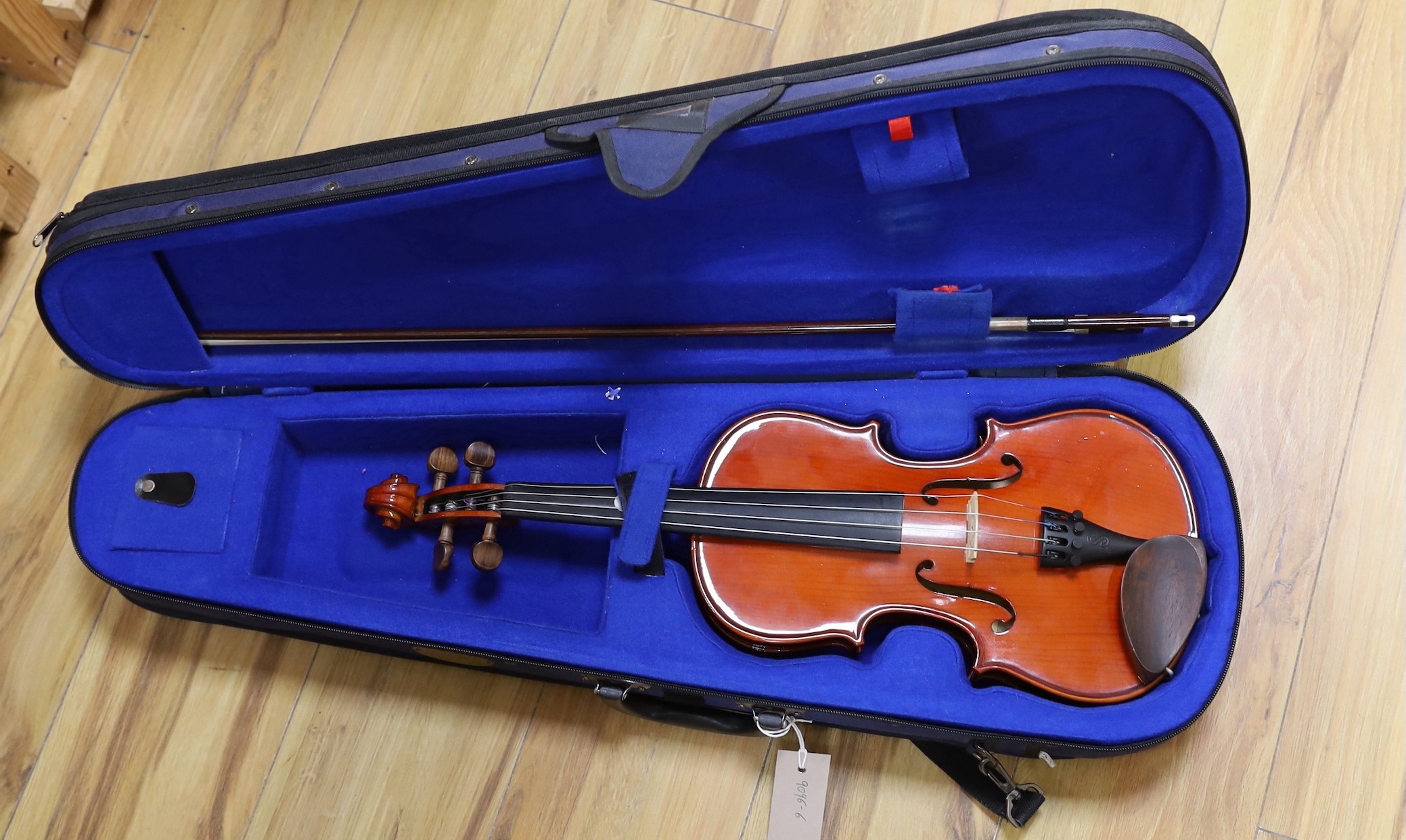 A cased violin and bow