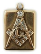 An Edwardian yellow metal and diamond cluster set masonic locket pendant, with engraved