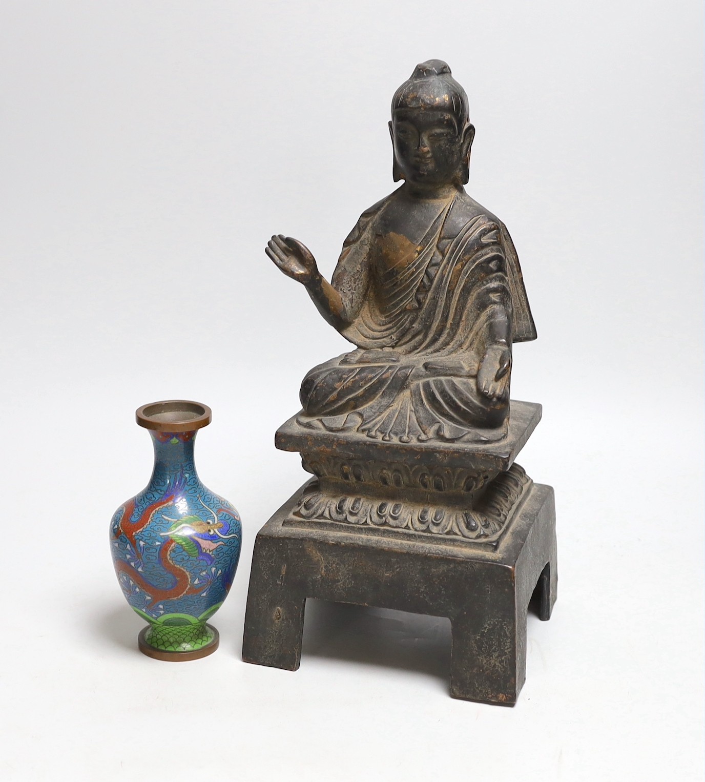 A Chinese or Japanese cast iron seated figure of Buddha and a cloisonne enamel ‘dragon’ vase,