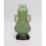 A Chinese carved bowenite jade vase and cover on hardwood stand, 23cm, with fitted case