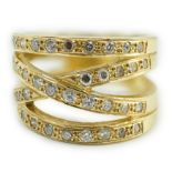 A modern 750 and diamond chip cluster set multi shank dress ring, size P, gross 10.1 grams.