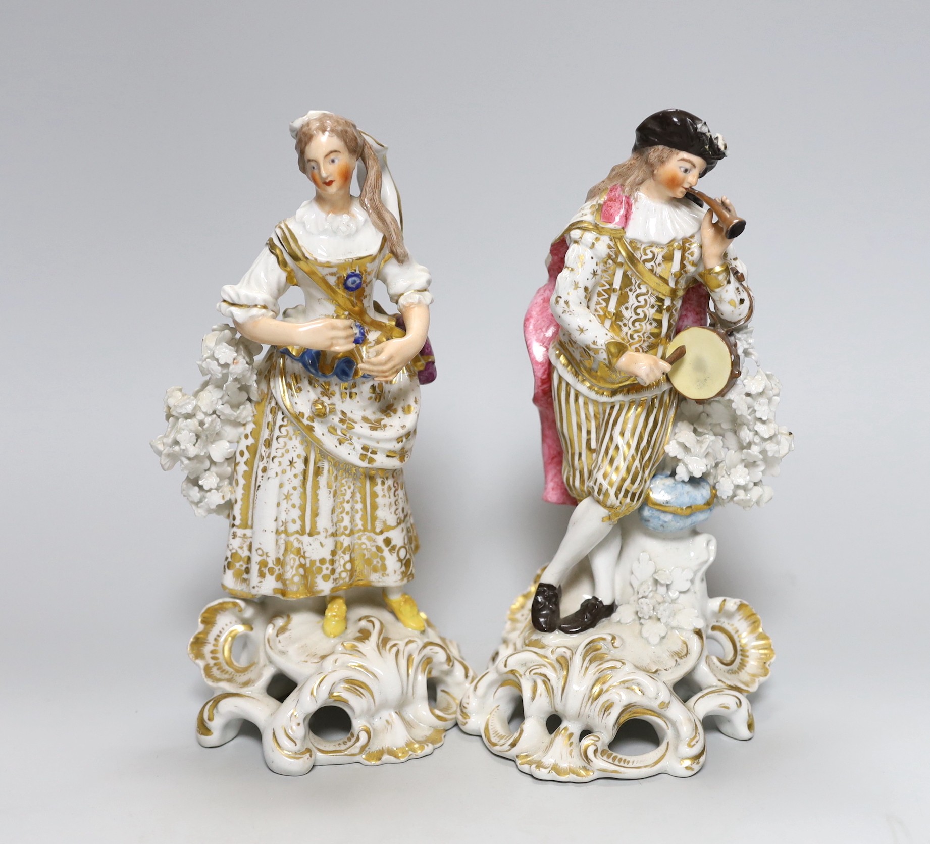 A pair of early 19th century Derby figures, the gentleman with flute and drum, 21cm