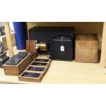 A magic lantern and a quantity of glass slides, including eleven novelty moving painted slides