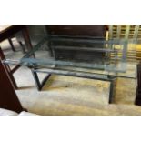 A rectangular glass topped cast metal coffee table, width 137cm, depth 76cm, height 46cm
