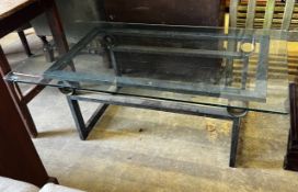 A rectangular glass topped cast metal coffee table, width 137cm, depth 76cm, height 46cm