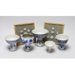 Five 19th century Chinese blue and white stem cups and two framed sets of Thai gaming counters,