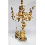 An ornate six branch ormolu cherub candelabrum, converted to a lamp, 54cms high