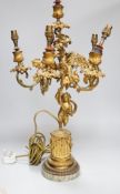 An ornate six branch ormolu cherub candelabrum, converted to a lamp, 54cms high