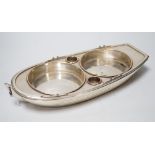 A late Victorian silver plated bottle coaster modelled as a rowing boat, 32cm long