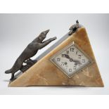 An Art Deco triangular marble and spelter clock, mounted with a fox chasing a bird, 39cms wide