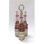 A Victorian three bottle ruby flashed glass and electroplate decanter stand, overall 46cms high