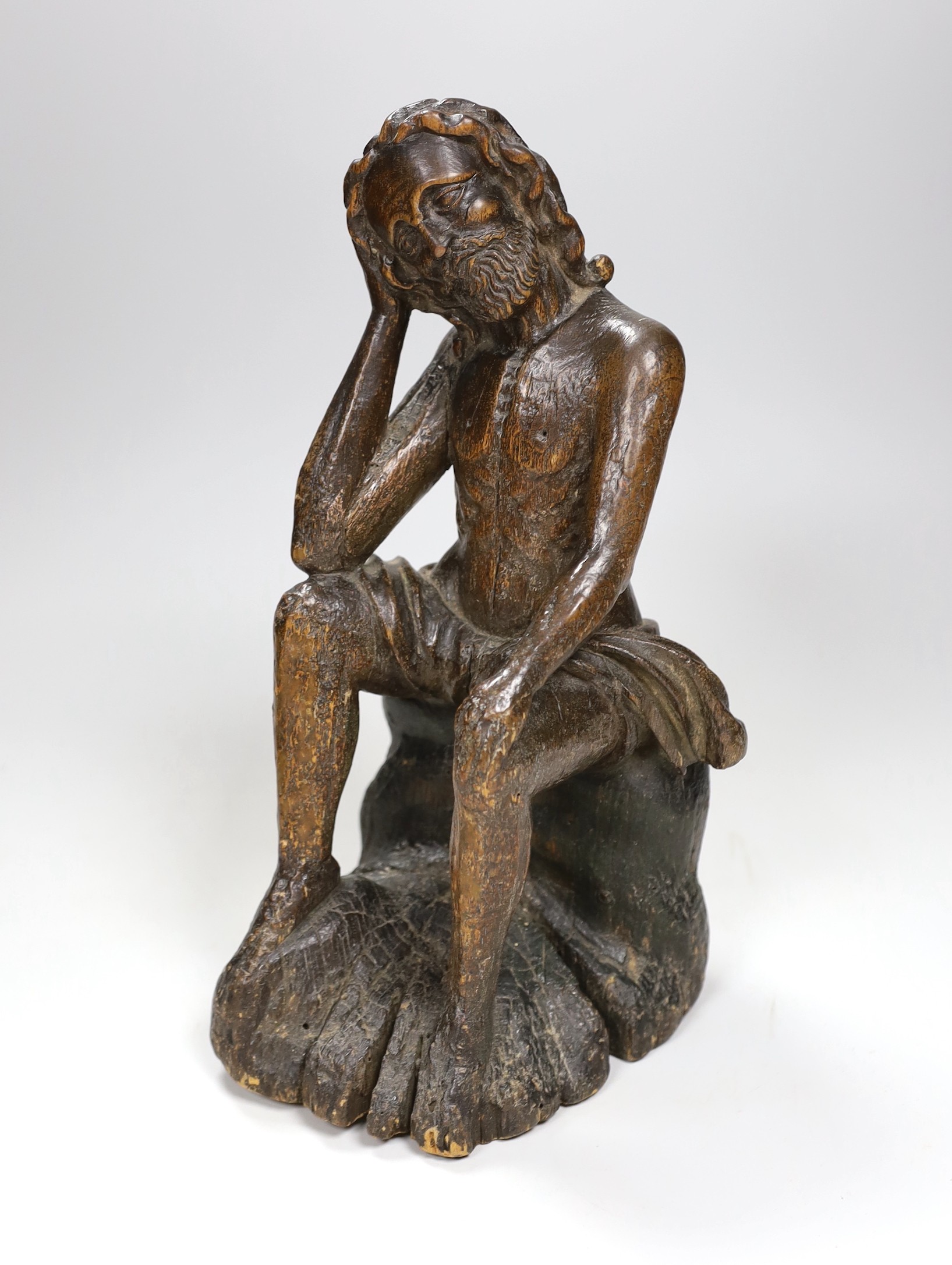 A 17th/18th century Italian limewood figural carving of Jesus perched, 31cm